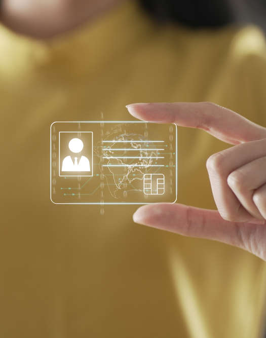 Montage: A person holds the icon of a digital ID card between their index finger and thumb and presents it to the camera.