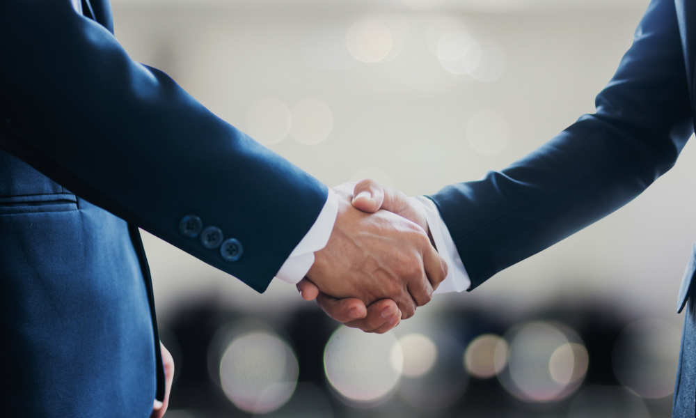 A firm handshake signals a successful business partnership.